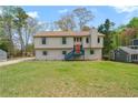Charming home with a well-maintained lawn, colorful front door, and unique architectural details at 1612 Sky Crest Dr, Lithia Springs, GA 30122