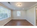 Bright bedroom featuring wood-look floors, crown molding, and plenty of natural light at 2070 Perkerson Sw Rd, Atlanta, GA 30310
