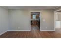 Open living room with wood-look floors and a view into the kitchen and other rooms at 2070 Perkerson Sw Rd, Atlanta, GA 30310