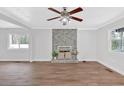 Bright living room with hardwood floors and a charming fireplace feature wall at 3640 Silver Leaf Sw Ln, Marietta, GA 30008
