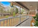 Inviting covered front porch with white railings and views of the quiet, tree-lined street at 3640 Silver Leaf Sw Ln, Marietta, GA 30008