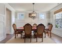 Traditional dining room with wainscoting, hardwood floors, a chandelier, and space for Gathering gatherings at 11395 Crestview Ter, Johns Creek, GA 30024