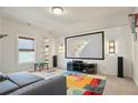Home theater with large projection screen, custom lighting and colorful rug at 11395 Crestview Ter, Johns Creek, GA 30024