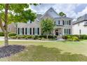 Charming two-story home with a well-manicured lawn, inviting front porch, and classic brick facade at 1718 Autumn Sage Dr, Dacula, GA 30019