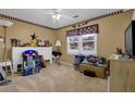 A bedroom with light brown carpet, a ceiling fan and red and white decorative border at 524 Lambeth Dr, Hiram, GA 30141