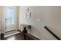 Inviting entryway with a console table, a frosted glass door and dark wood flooring, creating a warm welcome at 1671 Hammock Dr, Smyrna, GA 30080