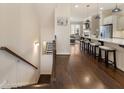 Open concept kitchen and living area with dark hardwood floors, white cabinetry, and a central island with seating at 1671 Hammock Dr, Smyrna, GA 30080