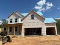 New construction of a two-story home with open garage, windows, and a partially built roof at 363 Riverwood Pass, Dallas, GA 30157