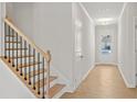Hallway featuring hardwood floors, white walls, and natural light, creating an open and airy atmosphere at 363 Riverwood Pass, Dallas, GA 30157