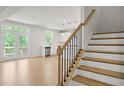 Light-filled living area with hardwood floors, leading to a modern kitchen and backyard access at 363 Riverwood Pass, Dallas, GA 30157