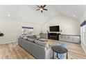 Bright living room with vaulted ceiling, hardwood floors, a sectional sofa and lots of natural light at 385 Jayne Ellen Way, Alpharetta, GA 30009