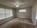 Cozy bedroom with carpeted floors, ceiling fan, and ample natural light from multiple windows at 3025 Mckenzie Rd, Atlanta, GA 30344