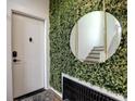 Stylish entryway featuring green foliage wall, gold mirror and stair access at 88 Peachtree Memorial Nw Dr # 88, Atlanta, GA 30309