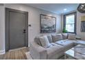 Comfortable living room with plush sofa, modern artwork, and bright window views at 88 Peachtree Memorial Nw Dr # 88, Atlanta, GA 30309