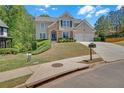 Attractive home with a manicured front lawn, two-car garage, and inviting curb appeal at 1210 Spring Branch Ct, Lawrenceville, GA 30045