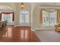 Bright foyer showcasing hardwood floors and arched doorways that lead to adjacent rooms at 1210 Spring Branch Ct, Lawrenceville, GA 30045