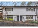 Exterior view of a multi-unit building with white brick and black shutters at 1683 Briarcliff Rd # 6, Atlanta, GA 30306