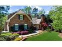 Attractive brick home showcasing well-maintained landscaping and brick walkway at 2675 Misty Morning Ln, Roswell, GA 30076