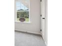 Bright room has a For Sale sign in the window and a white door at 27 Kensington St, Kingston, GA 30145