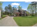 Charming brick home with attached garage and a long drive way at 45 Cherrystone Walk, Suwanee, GA 30024