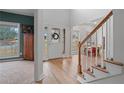 Bright foyer featuring hardwood floors, a staircase, and views into the dining and Gathering room at 45 Cherrystone Walk, Suwanee, GA 30024