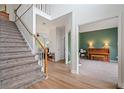 Entryway with hardwood floors, a staircase, and views into the adjacent rooms at 45 Cherrystone Walk, Suwanee, GA 30024