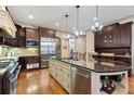 Gourmet kitchen with dark wood cabinets, stainless steel appliances, and granite countertops at 931 Fairfield Dr, Marietta, GA 30068