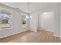 Bright dining room offering wood-look floors and a view of the front yard at 30 Riverrock Trl, Dallas, GA 30157