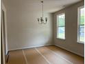 Bright dining room with natural light, classic chandelier, and neutral color palette at 30 Riverrock Trl, Dallas, GA 30157