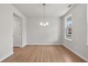 Bright dining room with wood floors and a modern chandelier at 30 Riverrock Trl, Dallas, GA 30157