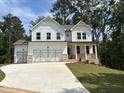 Charming two-story home with white siding, a spacious driveway, and a two-car garage at 30 Riverrock Trl, Dallas, GA 30157