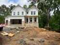 New two-story home under construction with brick foundation and attached garage at 30 Riverrock Trl, Dallas, GA 30157