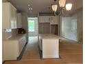 Open concept kitchen with white cabinets, granite counters, and central island at 30 Riverrock Trl, Dallas, GA 30157