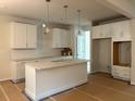 Spacious kitchen with white cabinets, granite countertops, and a central island at 30 Riverrock Trl, Dallas, GA 30157