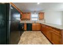 Kitchen with wood cabinets, granite countertops and black appliances at 895 Tyrell Dr, Austell, GA 30106