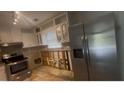 The kitchen is equipped with stainless steel appliances, white cabinetry, and under-cabinet lighting at 1430 Country Lane Ne Dr, Conyers, GA 30012