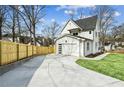Driveway leading to a bright two-car garage, adjacent to a newly installed wood fence at 1967 Nash Se Ave, Atlanta, GA 30316