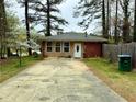 Single story home with a well-maintained driveway and yard at 6079 Zachary Ct, Norcross, GA 30093