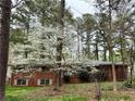 Cozy brick home nestled among mature trees and lush landscaping at 6079 Zachary Ct, Norcross, GA 30093