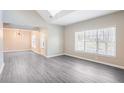 Spacious living room with high ceilings, natural light, and modern gray wood flooring at 1784 Hollingsworth Nw Blvd, Atlanta, GA 30318