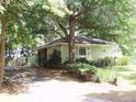 Single-story home with green exterior with mature shade trees at 1908 Bouldercrest Se Rd, Atlanta, GA 30316