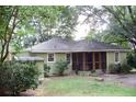 A quaint single-story home featuring a screened-in porch and mature shade trees at 1908 Bouldercrest Se Rd, Atlanta, GA 30316