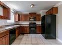 Functional kitchen with black appliances, ample cabinetry, and neutral tile flooring at 2619 Del Ridge Dr, Douglasville, GA 30135