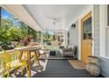 Inviting front porch with stylish furniture, ceiling fan, and a yellow door at 323 Fayetteville Rd, Decatur, GA 30030