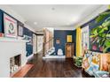 Charming living room with a fireplace, hardwood floors, and blue accent walls at 323 Fayetteville Rd, Decatur, GA 30030