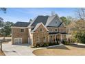Gorgeous home with a large driveway, attached garage and a basketball court in a wooded lot at 3669 High Green Dr, Marietta, GA 30068