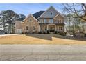 A beautiful two story house showcasing manicured lawn, brickwork, and manicured landscaping at 3669 High Green Dr, Marietta, GA 30068
