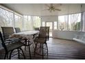 A screened patio with chairs and table, perfect for outdoor dining and relaxing during warm weather at 1191 Crofton Landing, Suwanee, GA 30024