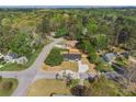 Wide aerial shot of the property in a wooded neighborhood with mature trees and landscaping at 1857 Taffeta Trl, Lithonia, GA 30058