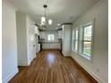 Kitchen and dining area with white cabinets and modern lighting fixture at 438 Holly Nw St, Atlanta, GA 30318